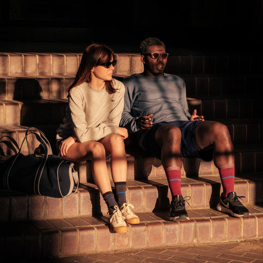 A man and woman sitting on stairs.